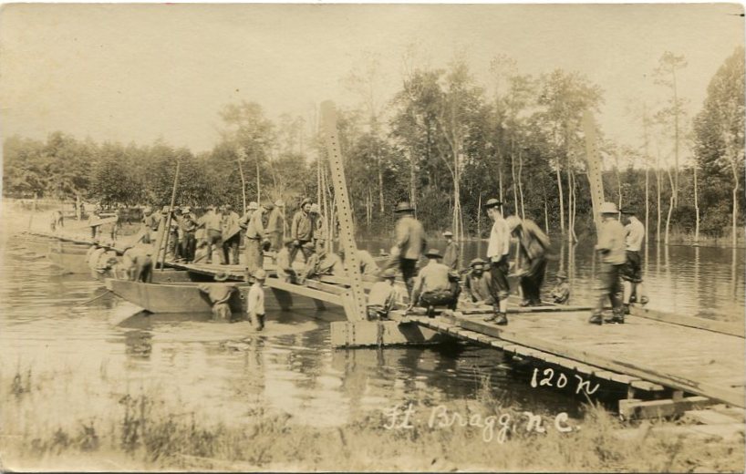 ENGReal-photo postcard of a photograph of U.S. Army soldiers building a pontoon bridge over a body of water at Fort Bragg, N.C., around the 1920s [circa 1920s].
