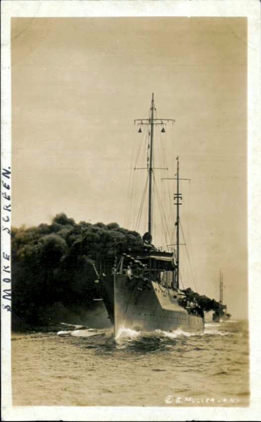 Real-photo postcard of two U.S. Navy boats, with their chimneys billowing dark black smoke as a smoke screen, while at sail during World War I