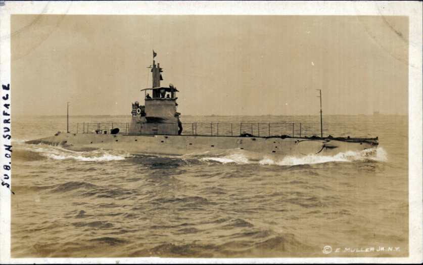 Real-photo postcard of a photograph of a U.S. Navy submarine sailing on the surface of the water somewhere along the Atlantic Coast during World War I
