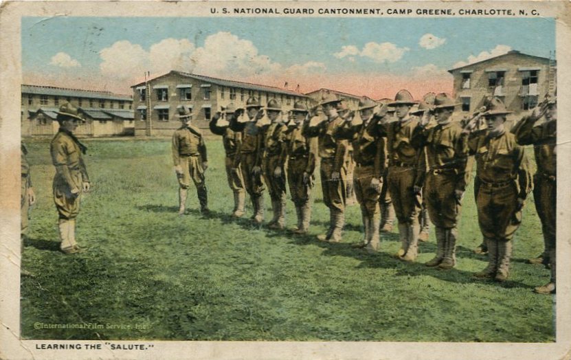 Picture postcard of a view of U.S. Army soldiers saluting during a training drill at the U.S. National Guard Cantonment at Camp Greene, N.C., during World War I. Postcard contains message from a man named Getz to Mary E. Early of Nokesville, Virginia, in June 1921 [circa 1910s] [Postcard by: C. T. American Art and Southern Post Card Company, Asheville, N.C.].