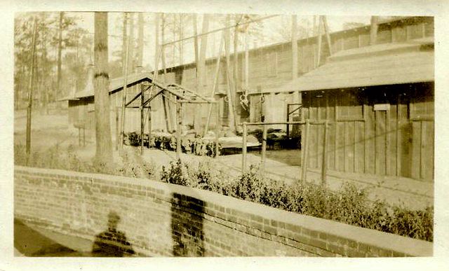 Snapshot of the front of the outdoor area around the barracks and training area for the Supply Company of the 9th Regiment [Training] at Camp Jackson, S.C., around 1918 during World War I. Photograph taken or collected by Willie H. Mann of Chatham County, N.C., while he was stationed in the 81st Infantry Division, U.S. Army, at Camp Jackson [circa 1918].